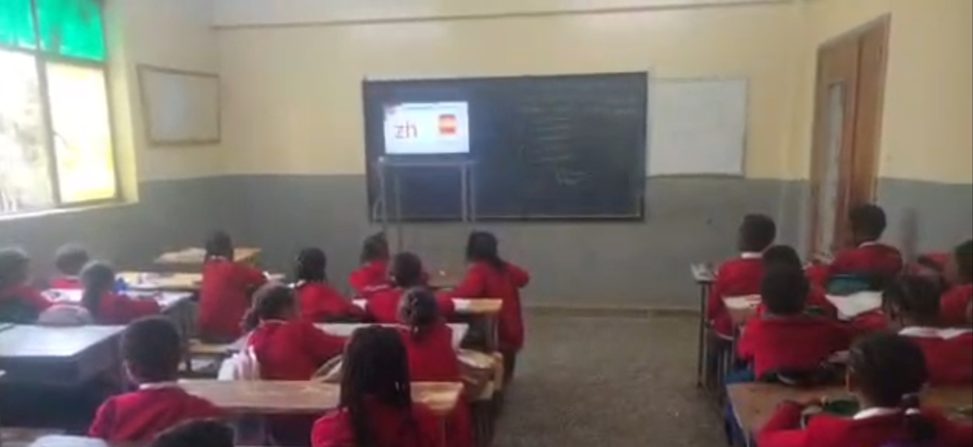 BMYS students in red uniforms during a classroom lesson